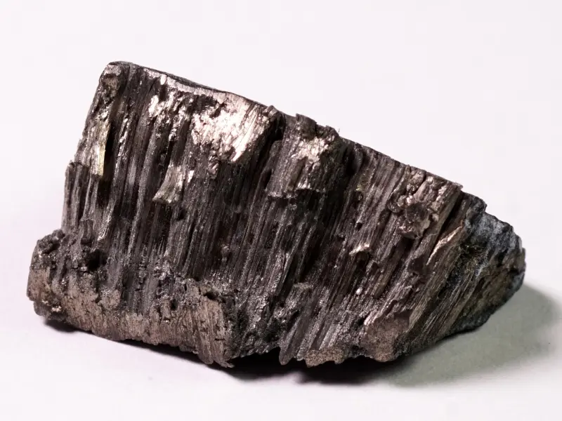 Dark grey gadolinium metal piece with a crystalline structure