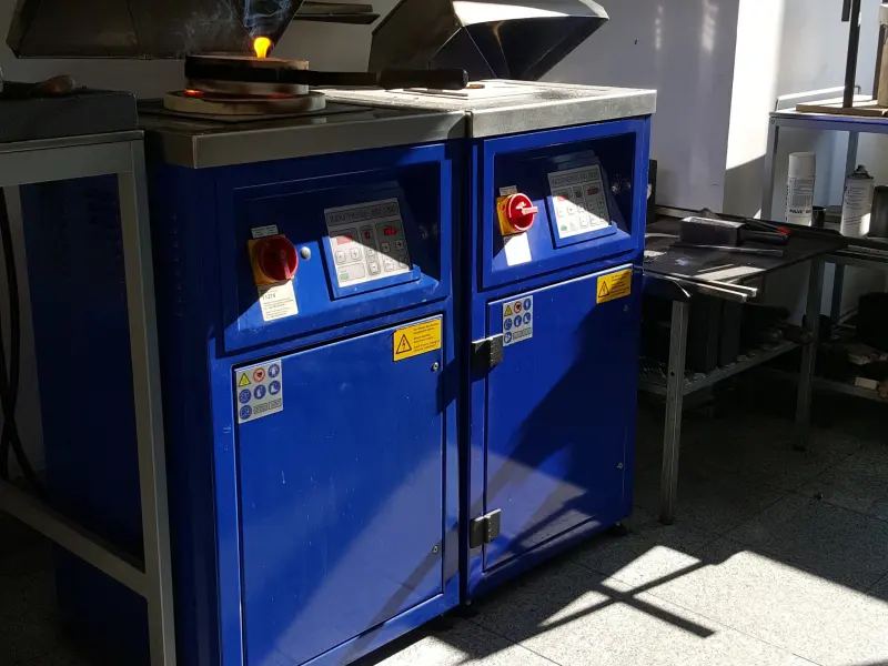 Two blue industrial furnaces for metallurgical processing
