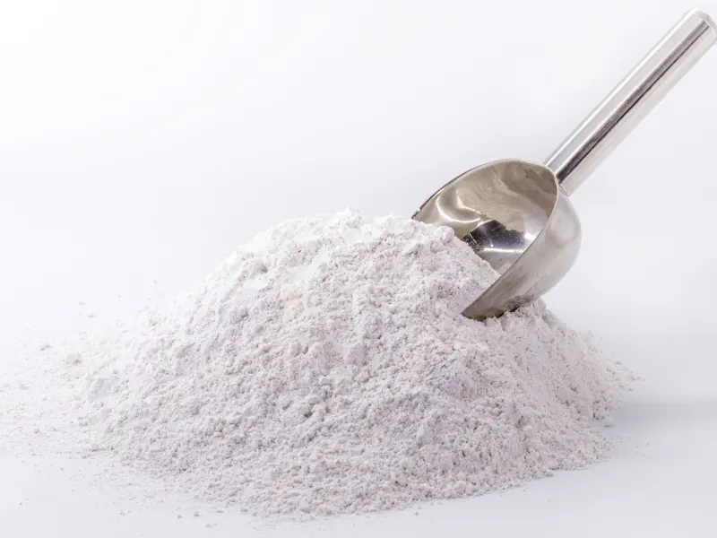 Light samarium oxide powder with a laboratory scoop